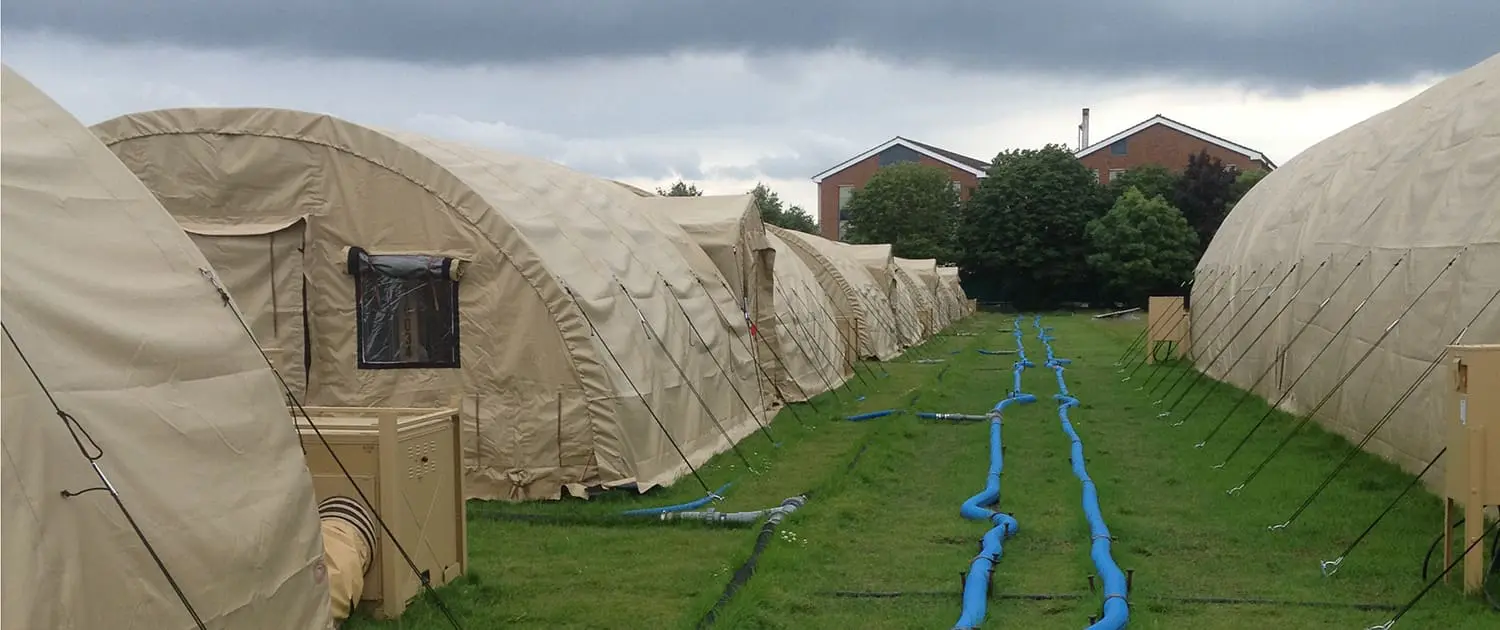 London Olympics temporary security accommodation Deployable vacuum systems used in temporary camp facility. vacuum mains laid above ground